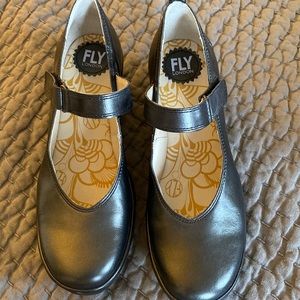 Fly London shoes. The color is a metallic silver.
